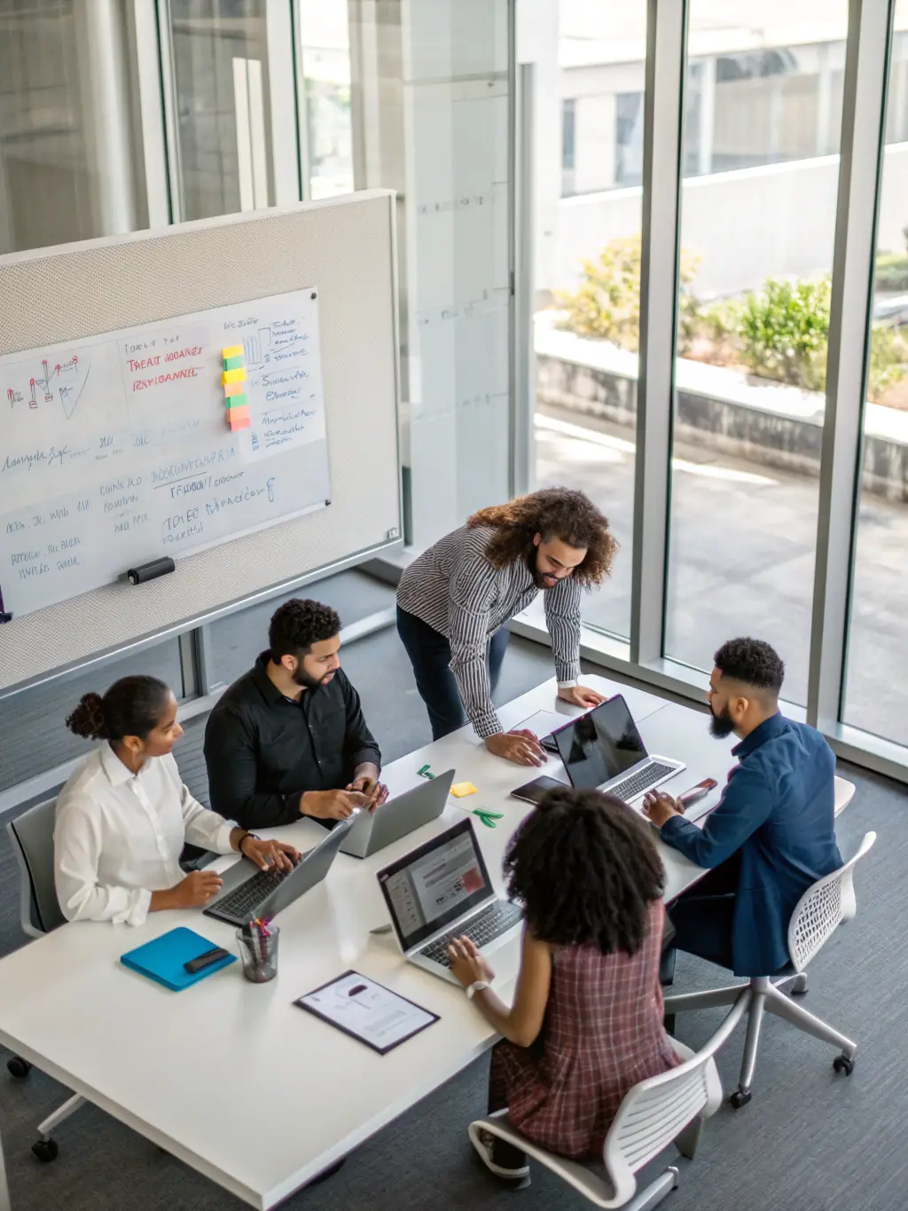 A diverse team of IT specialists collaborating on a complex project, showcasing Al Tajdeed's comprehensive skill set and collaborative approach.